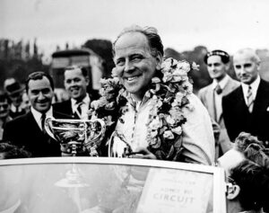 MTR24-Blog-Reg Parnell, winner of the August Trophy Race, with the trophy, and the Victor's Laurel Wreath 