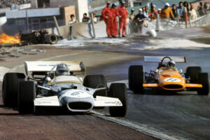 MTR24-Blog-Graham Hill, Bruce McLaren, Lotus-Ford 49C, McLaren-Ford M14A, Grand Prix of Spain, Circuito del Jarama, 19 April 1970. Graham Hill's Lotus 49C is covered in fire extinguisher foam following the fiery accident that involved Jackie Oliver and Jacky Ickx.